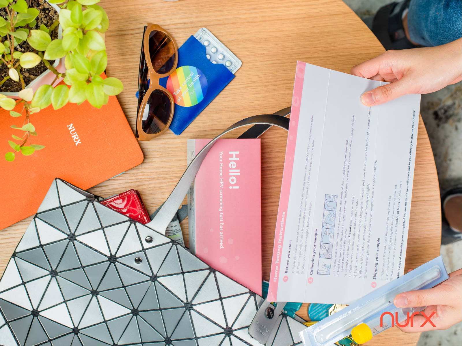 Nurx product flat-lay with sunglasses, wallet and prescription packaging