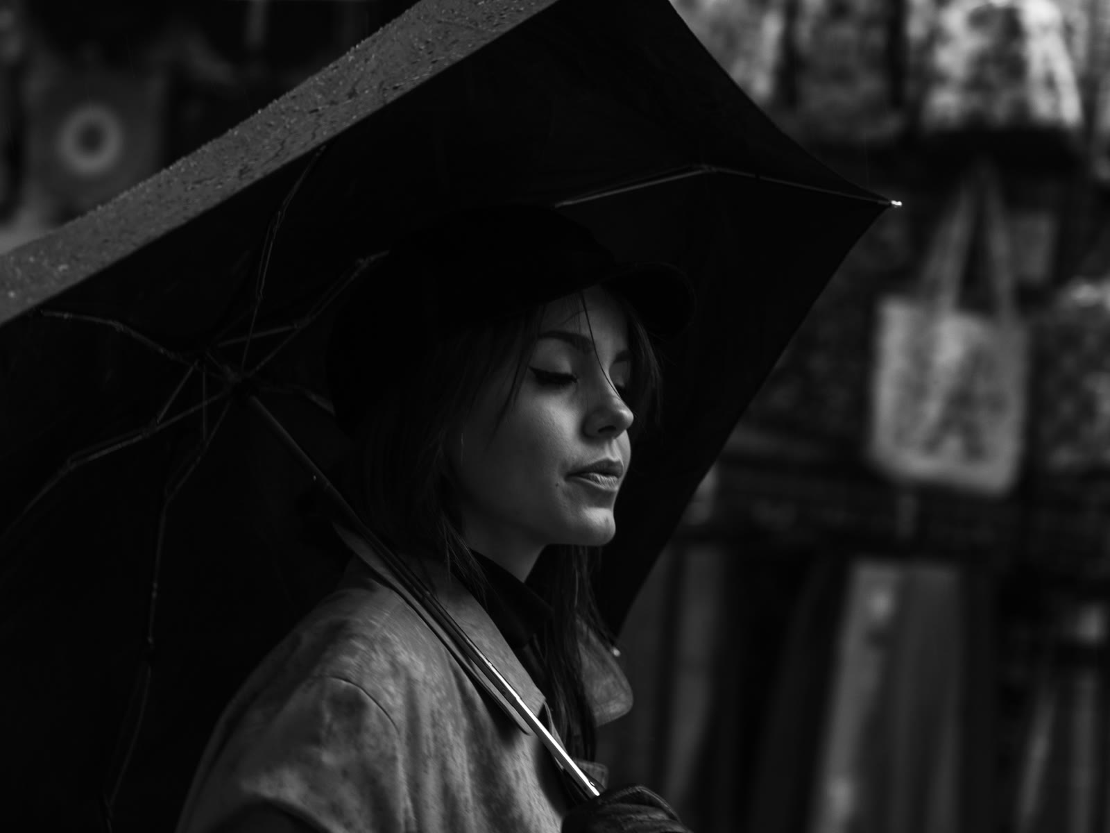 Black-and-white portrait under an umbrella in the rain