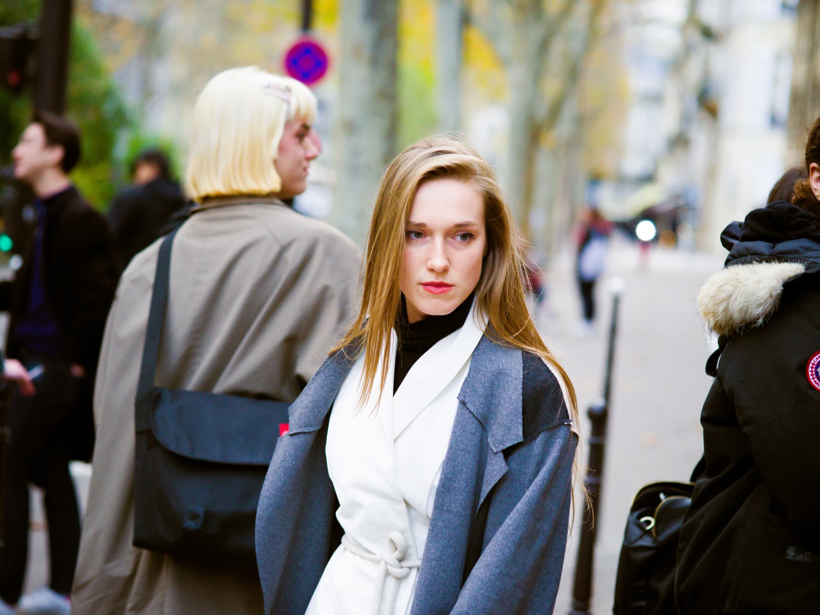 Two women walking together on a Paris sidewalk